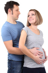 Fototapeta premium Young pregnant woman with her husband isolated on white