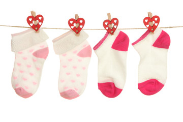 Socks hanging on clothesline isolated on white