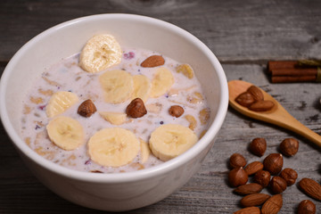bowl of muesli and millk with fresh banana close up