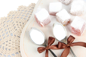 Obraz na płótnie Canvas Tasty oriental sweets (Turkish delight) with powdered sugar,