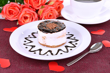 Sweet cake with chocolate on plate on table close-up