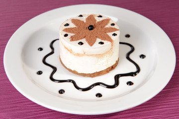 Sweet cake with chocolate on plate on table close-up
