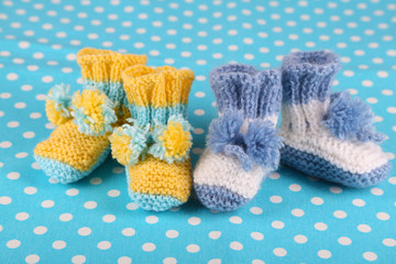 Crocheted booties for baby, on color background