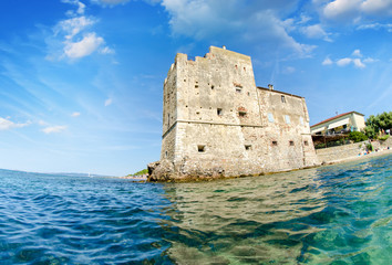Ancient tower over the ocean, view from the water