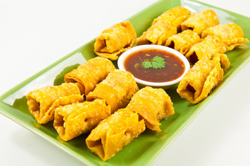 Fried dumplings  wrapped hotdog on green dish