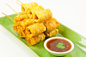 Fried dumplings  wrapped hotdog on green dish