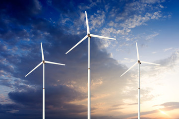 Green renewable energy concept - wind generator turbines in sky