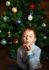 Boy is kissing and christmas tree