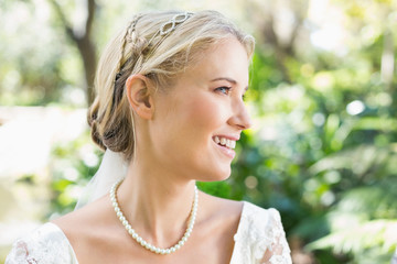 Happy blonde bride wearing pearls