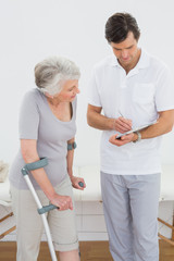 Fototapeta premium Therapist discussing reports with a disabled senior patient