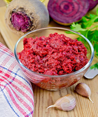 Beet caviar in a glass bowl on a blackboard