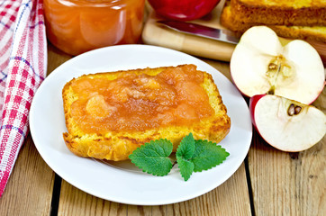 Bread with apple jam and apple on a board
