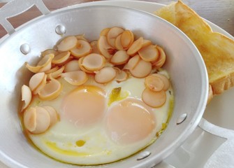 Fried eggs And Sausages served with toast
