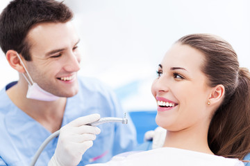 Male dentist and woman in dentist’s office