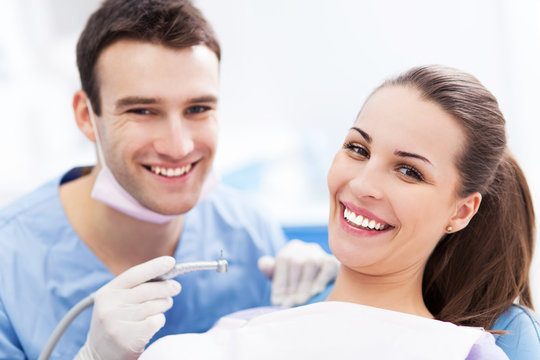 Male dentist and woman in dentist’s office