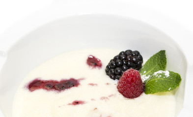 semolina porridge with berries decorated with berry jam