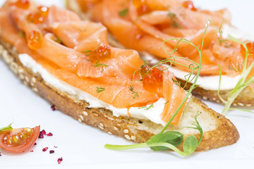 sandwiches with salmon caviar and greens adorned
