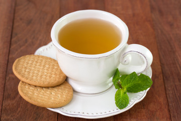 white cup of tea with cookies