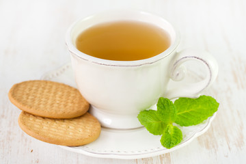 cup of tea with cookies and mint