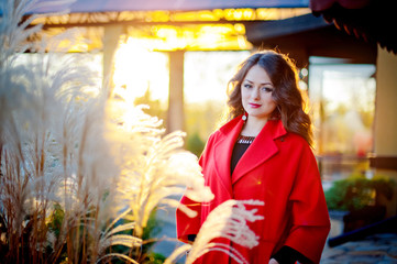 Obraz premium Beautiful elegant woman in a red coat