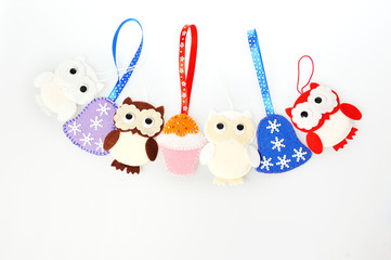 Handmade Christmas decorations toys of felt owls, bells, cakes