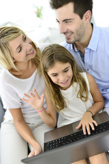 Family having fun chating on internet with laptop