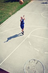 Basketball player jumping and shooting the ball