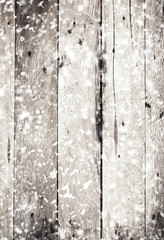 Old Rustic Wood wall texture with white falling snowflakes close