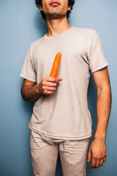 Serious young man with carrot