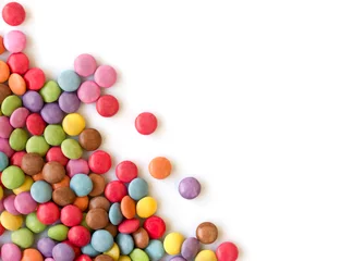 Wall murals Sweets Smarties in corner, rounded colorful candies isolated on white background