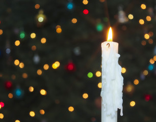 A White Christmas Candle with Blurred Lights