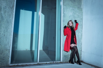 Beautiful girl posing with red coat