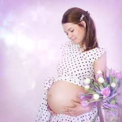 Beautiful pregnant woman portrait with tulips.