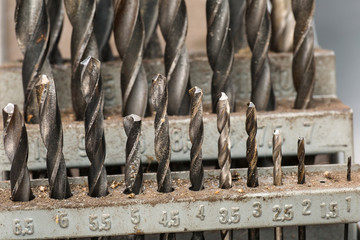 Set of used drill bits in a workshop