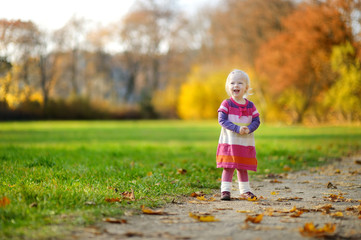 Adorable toddler girl portrait on autumn day