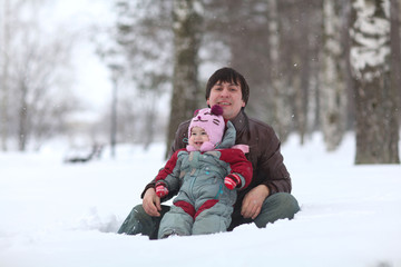 Fototapeta na wymiar Dad and his daughter having fun in winter