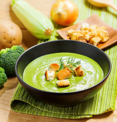 Broccoli cream soup and ingredients on table
