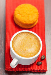 Coffee cup and cookies on a table, top view