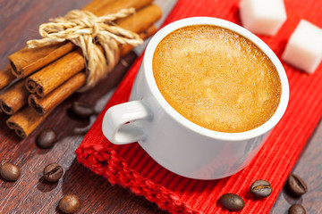 Coffee cup, cookies and cinnamon on a table