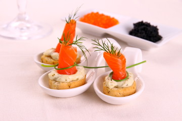 Smoked Lachsrollchen on white bread chunks