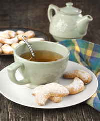 Crescents vanilla and almond cookies and cup of green tea