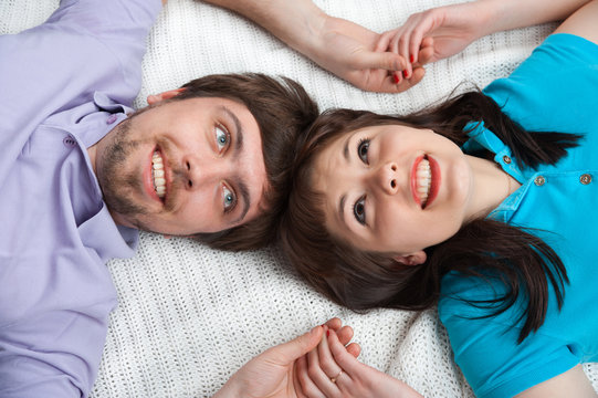 Couple looking up in bed