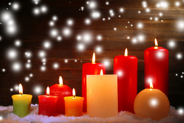 Burning candles on wooden background