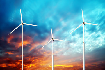 Green renewable energy concept - wind generator turbines in sky