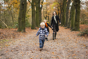 Fototapeta premium Boy and family in woods or forest