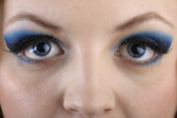 Fototapeta premium close-up portrait of beautiful girl's eye-zone make-up with blue