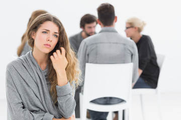 Therapy in session sitting in a circle while woman in foreground