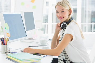 Casual woman with headset using computer in office