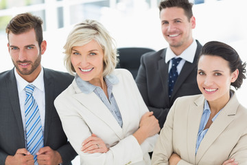 Confident business team with arms crossed in office