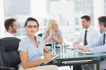 Businesswoman with colleagues discussing in office